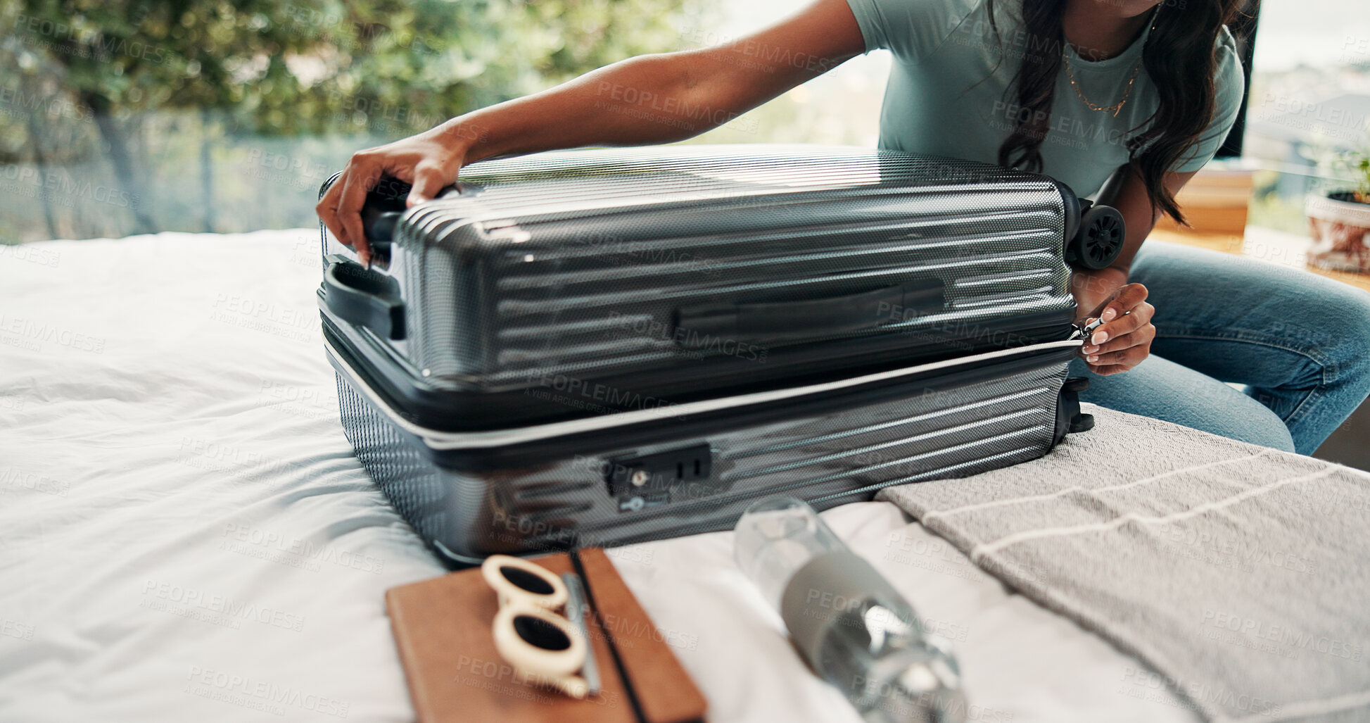 Buy stock photo Hands, packing and suitcase with person on bed in home for holiday, travel or vacation. Closing, getting ready and luggage with tourist or traveler in bedroom of apartment for trip preparation