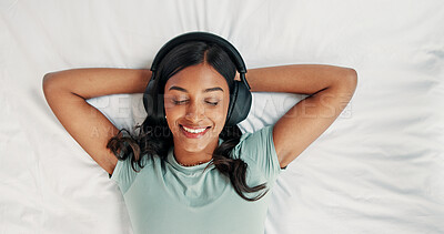 Buy stock photo Relax, happy woman and listening with headphones on bed, digital subscription service and podcast from above. Weekend rest, radio and person streaming music with tech, chilling and audiobook in home