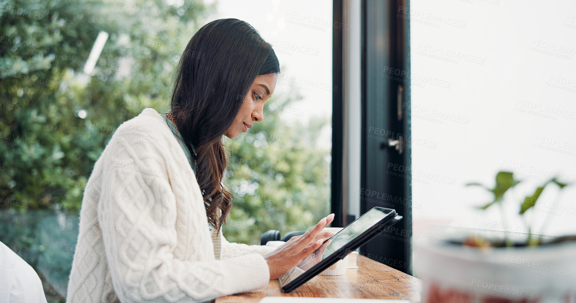Buy stock photo Remote work, scrolling and tablet with woman in home for online planning or research at window. App, development and reading with freelance employee at desk in apartment for small business startup