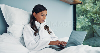 Buy stock photo Freelancer, bed and woman typing on laptop in home for online article, inspiration or writing publication. Remote work, copywriter and story plot in robe for proofreading or email response in bedroom