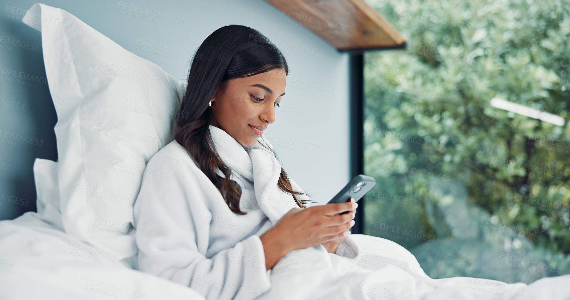 Buy stock photo Phone, relax and woman in bedroom for internet communication, online dating app or chat. Rest, bed and Indian person with mobile for social media post, morning notification and profile info in home
