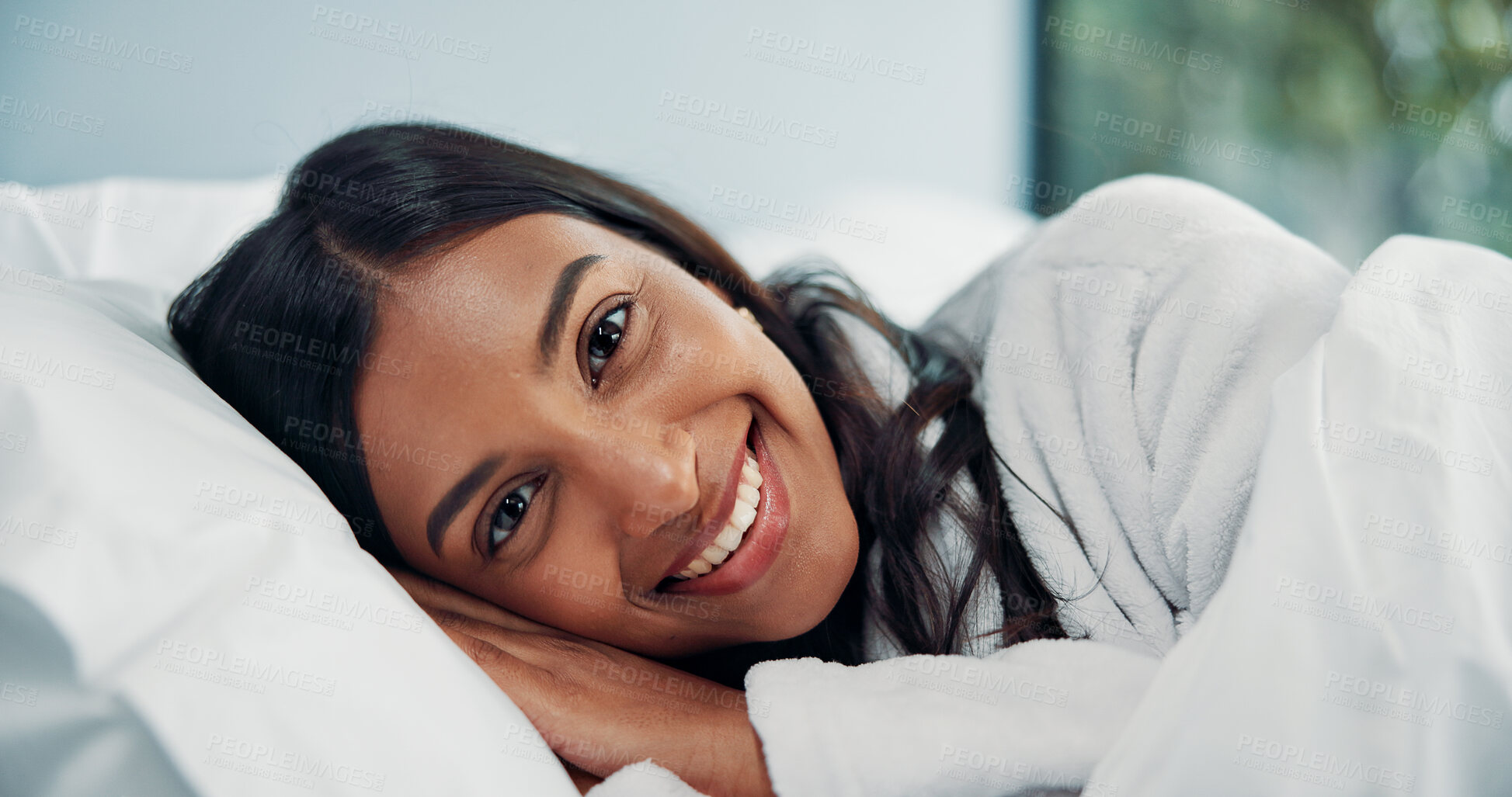 Buy stock photo Break, portrait and smile of woman in bed for comfort, cozy or wellness on lazy weekend morning. Awake, relax and travel with happy Indian person in hotel bedroom for accommodation or hospitality