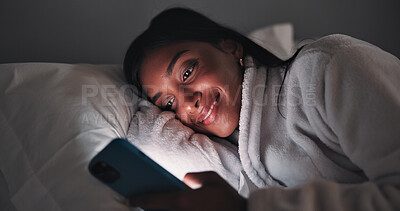 Buy stock photo Streaming, night or woman in bedroom with phone, online reading or video browse on social media. Smile, dark or girl in house with tech, e book subscription or digital scroll in late evening.