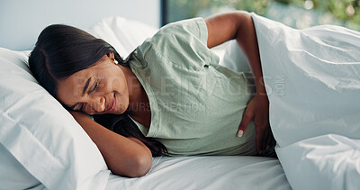 Buy stock photo Pain, menstruation and woman in house with massage, discomfort and stomach ache in symptoms. Health, cramps and female person in bed with belly rub, endometriosis and soothe abdominal hurt on cycle.