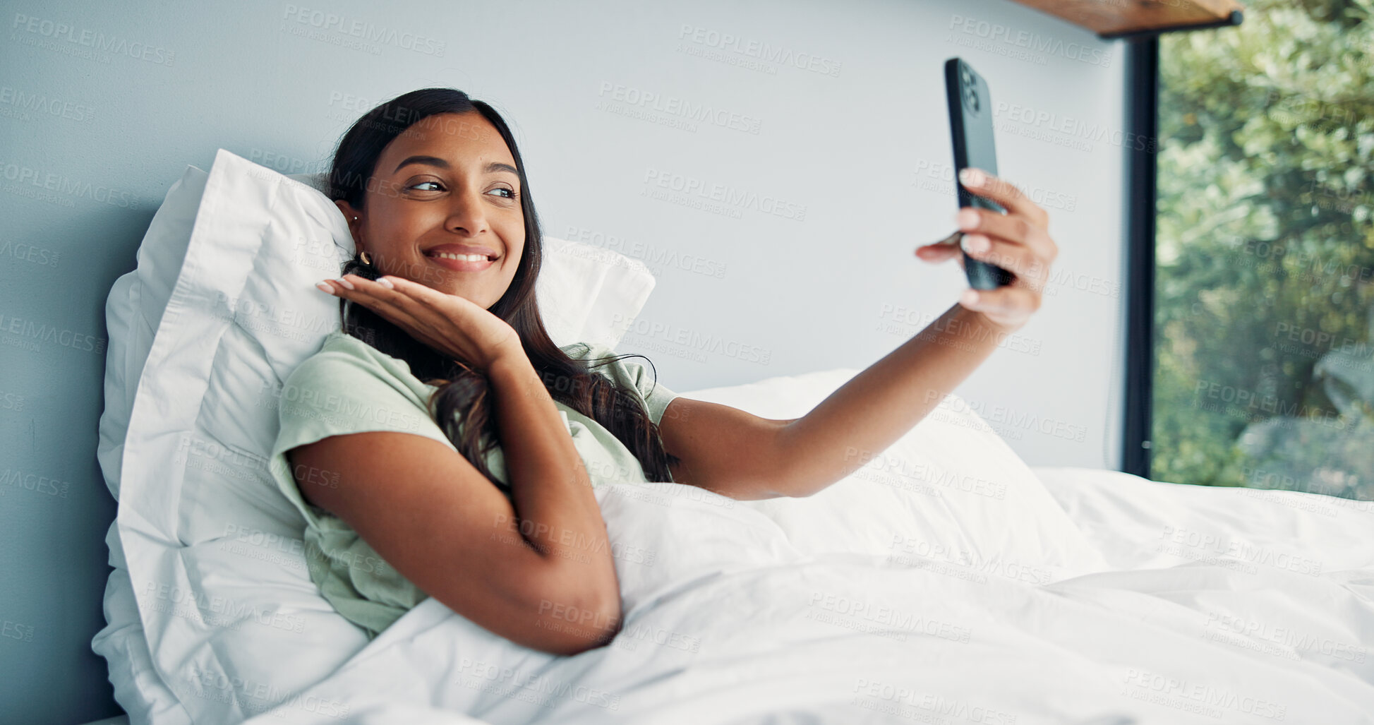 Buy stock photo Photography, happy woman and pose for selfie in bed, cozy morning and smile for profile picture update. Relax, social media post and Indian person with wake up photo, comfortable and rest in home