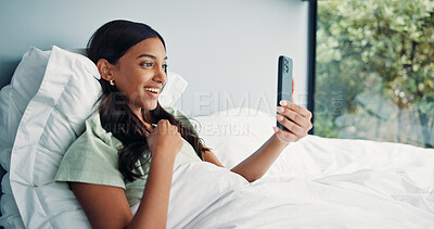 Buy stock photo Relax, woman and video call with phone on bed, online communication and morning chat on weekend. Digital app, comfortable and happy person talking with mobile, connection and conversation in home