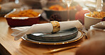 Christmas, feast and napkin with place setting on dining room table for social gathering. Banquet, celebration event and ring on serviette in home for decoration, meal or party in holiday season