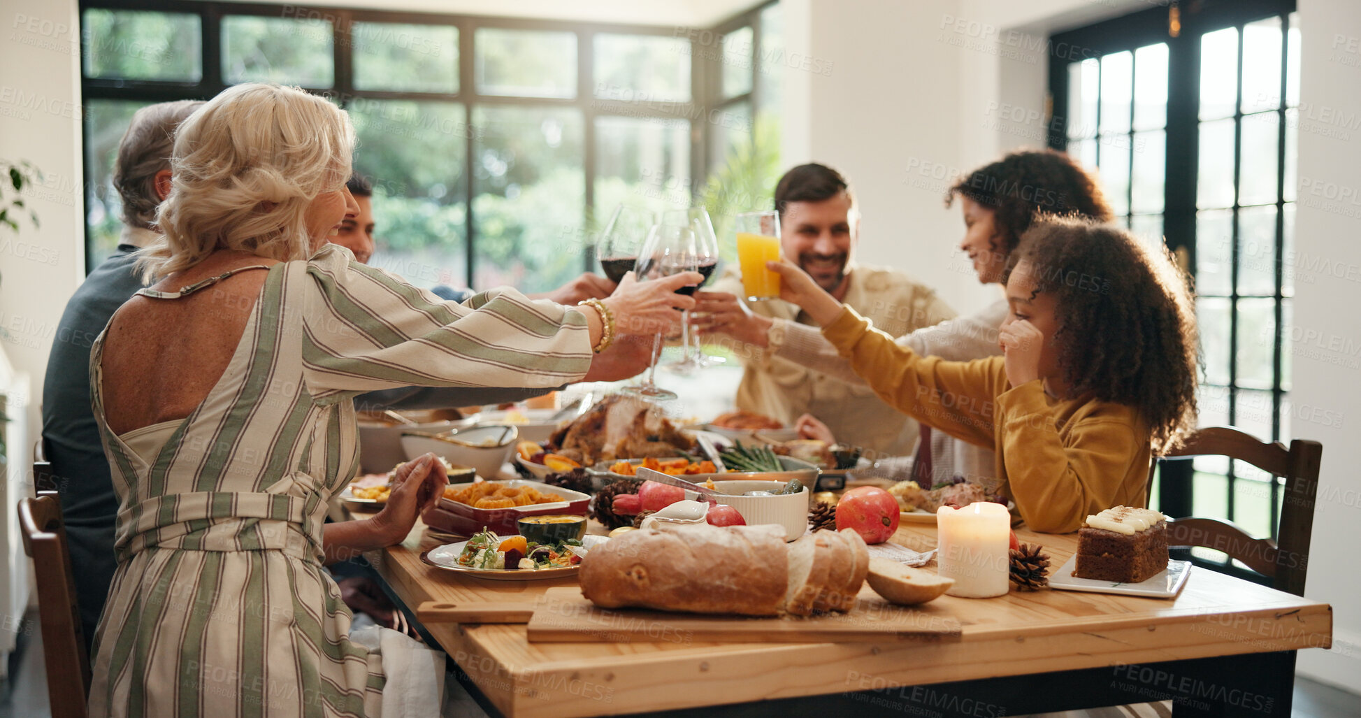 Buy stock photo Christmas, toast and family with wine, feast or group with meal in dining room, celebration and home. Xmas, cheers and people with alcohol for December holiday, gathering and party for festive season