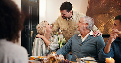 Buy stock photo Thanksgiving, happy and talking with family in dining room for holiday season, dinner or tradition. Festive feast, party and event with people eating in home for food, hosting and hospitality