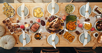 Buy stock photo Above, table and food for thanksgiving at house with roast turkey, healthy vegetables and celebration. Candles, feast and cuisine setup with wine glass, nutrition meal and lunch tradition for festive