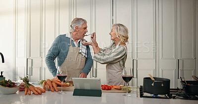 Buy stock photo Cooking, taste and senior couple in kitchen for lunch, online recipe and prepare food for bonding in home. Tablet, retirement and old man and woman for meal prep, wine and help for anniversary dinner