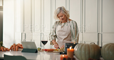 Buy stock photo Mature woman, tablet or cutting on kitchen counter, prepare ingredients or video tutorial for dinner. Online recipe, blog post or person chop vegetables for healthy food, tech or cooking instruction