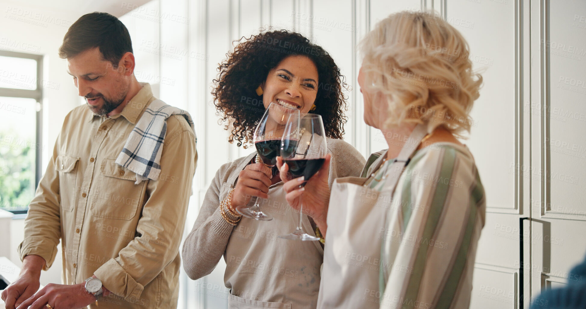 Buy stock photo Women, family and cheers with alcohol for cooking, reunion celebration and bonding together. Happy, senior mother and people toast with red wine, meal preparation and thanksgiving gathering at house