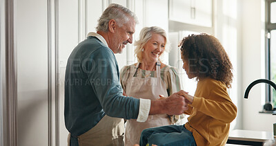 Buy stock photo Dance, thanksgiving and grandparents with child in kitchen for support, cooking and reunion. Happiness, festive season and bonding with senior people and kid holding hands in family home for holidays
