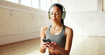 Buy stock photo Music, phone and yoga with woman in studio for fitness tracking, holistic health or streaming. App, headphones and typing with yogi person in class for communication, subscription or wellness