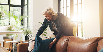Buy stock photo Mature woman, cleaning and couch at house for real estate, tidy living room and interior comfort. Female realtor, arrange and cushion for furniture decoration, neat sofa and preparation for viewing