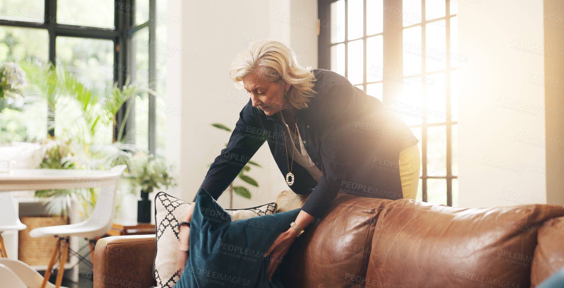 Buy stock photo Mature woman, cleaning and couch at house for real estate, tidy living room and interior comfort. Female realtor, arrange and cushion for furniture decoration, neat sofa and preparation for viewing