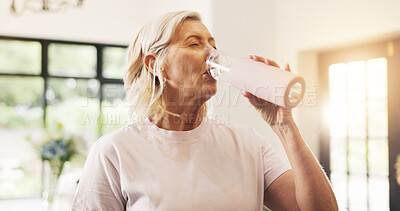 Buy stock photo Fitness, woman and drinking water in home with bottle for hydration, yoga workout and exercise break. Active, mature female person and wellness with beverage for thirst, electrolytes and recovery.