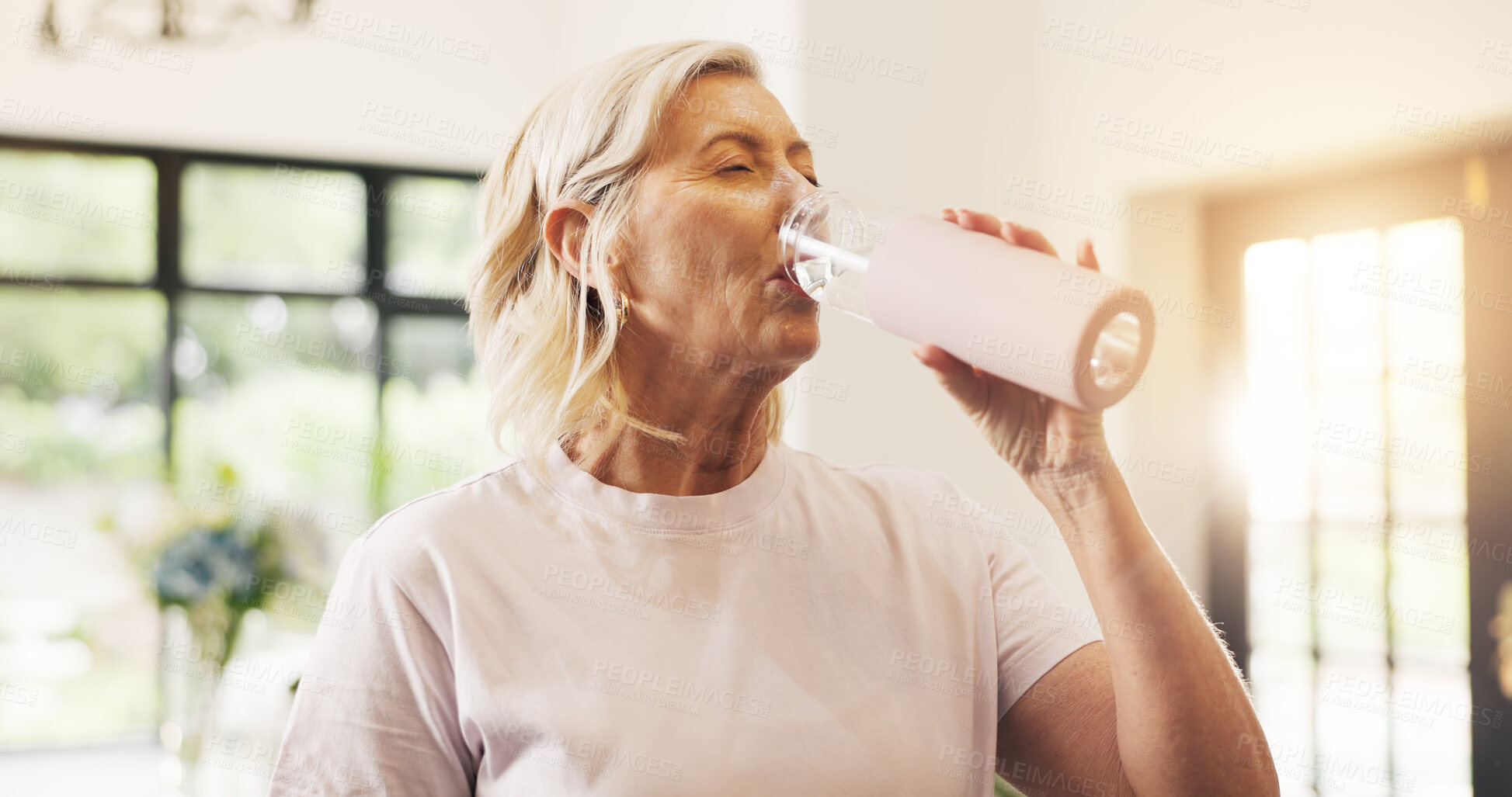 Buy stock photo Fitness, woman and drinking water in home with bottle for hydration, yoga workout and exercise break. Active, mature female person and wellness with beverage for thirst, electrolytes and recovery.
