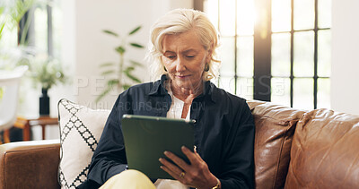 Buy stock photo Senior woman, tablet and relax on sofa with scroll, notification or reading ebook in lounge at home. Elderly person, tech and smile with application, story and video on social media in retirement