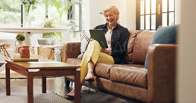 Buy stock photo Senior woman, tablet and laugh on sofa with joke, notification or reading ebook in lounge at house. Elderly person, tech and relax on app, flare and funny video with social media in retirement home