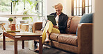 Senior woman, tablet and laugh on sofa with joke, notification or reading ebook in lounge at house. Elderly person, tech and relax on app, flare and funny video with social media in retirement home