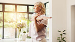 Senior woman, exercise and stretching arms in home with warm up, flexibility and routine in morning. Elderly person, fitness and ready with muscle development, workout or flare in retirement at house