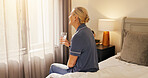 Thinking, old woman and water on bed in morning for hydration, digestion and health benefits. Retirement, senior person and reflection with liquid beverage in home for metabolism, thirst and wellness