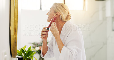 Buy stock photo Mature woman, hairbrush and grooming in bathroom, mirror or profile with morning routine at house. Person, self care and smile for hairstyle, tools and brushing hair for texture, beauty or results