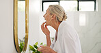 Mature woman, mirror and lips in bathroom for beauty, apply product and exfoliation with scrub. Female person, cosmetics and sugar mask for hydration, nourishing treatment and healing cream at house