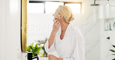 Buy stock photo Home, mirror and old woman in bathroom, gua sha and skincare with dermatology, shine and beauty. Apartment, pensioner and mature person with cosmetics, wellness and anti aging with facial massage