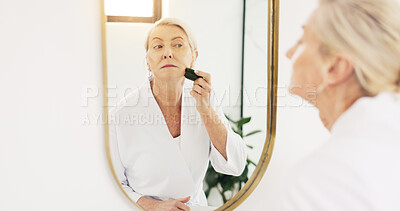 Buy stock photo Senior woman, gua sha and skincare in bathroom mirror with tools, circulation and beauty in house. Elderly person, anti aging and reflection for blood flow, massage and dermatology in retirement home
