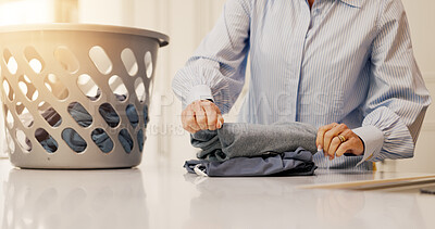 Buy stock photo Spring cleaning, home and hands with laundry, folding and sorting clothes, housework and maintenance. Organizing, fabric and person with chores in kitchen, task and cleanliness of house or hygiene