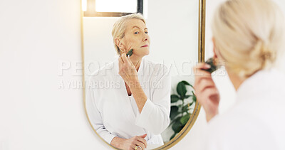 Buy stock photo Mature woman, gua sha and beauty in bathroom mirror with tools, circulation or skincare in house. Person, anti aging and stone with reflection for blood flow, massage and dermatology at apartment