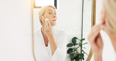 Buy stock photo Woman, mirror and makeup removal in bathroom, hygiene and skincare routine with cotton pad in house. Grooming, reflection and mature person with wipe for facial cleansing, home and beauty cosmetics