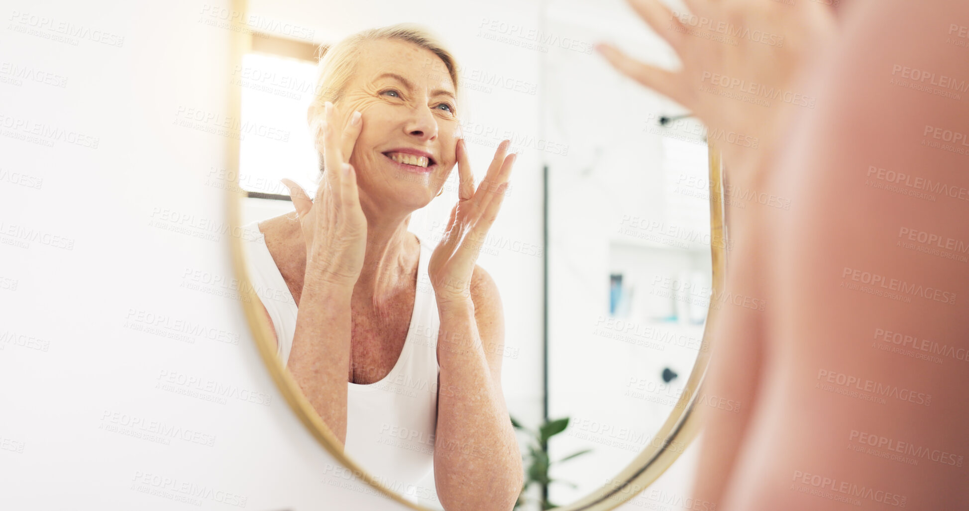 Buy stock photo Mature woman, beauty cream and bathroom mirror for hydration, moisturizer or happy with skincare in home. Female person, reflection and smile for anti aging benefit, dermatology or lotion in house