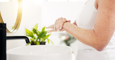 Buy stock photo Skincare, mature woman and hand cream in bathroom for skin hydration, moisturizer and dermatitis. Morning routine, person and apply lotion in home for eczema treatment, anti aging and SPF protection