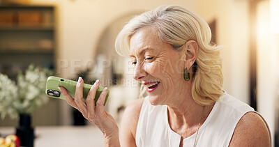 Buy stock photo Senior, happy woman and talking with speaker phone in home for communication or friendly discussion. Female person, smile or mobile smartphone with loudspeaker for call, audio message or voice note