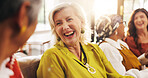 Laughing, old women and gossip on couch, home and bonding with friends in lounge, happy and reunion. Senior people, conversation and humor for funny joke in living room, flare and break in apartment