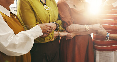 Buy stock photo Holding hands, old women and group with unity, solidarity and bonding together with comfort. Pensioners, closeup and people with gesture, support and trust with friends, lens flare and community