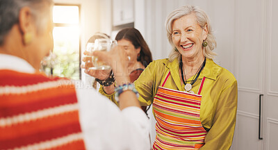 Buy stock photo Senior people, cheers and alcohol in kitchen for cooking, celebration and bonding together. Smile, elderly women and toast drink with friends of reunion, meal preparation and social gathering in home