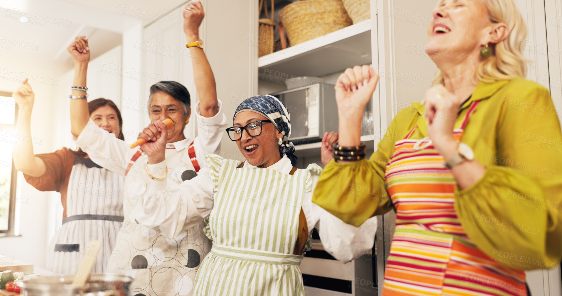 Buy stock photo Mature, happy women and dancing with food in kitchen for social gathering or celebration in home. Group, female people or friends with smile, vibe or vegetables for cooking success together in house