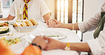 People, holding hands and praying with food on dining table for gratitude, appreciation and faith. Group, friends or social gathering with trust, meal or hope for culture, feast or tradition in home