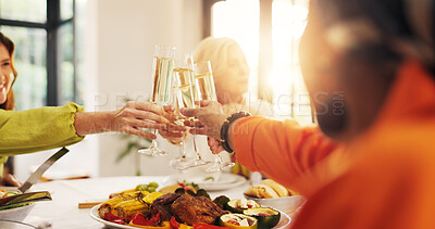 Buy stock photo Women, hands and glasses with cheers, food or meal for celebration or gathering together in home. People, toast or group of friends with champagne, dinner or feast for reunion or party in house