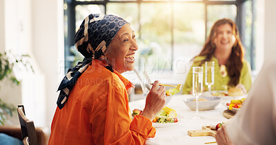 Buy stock photo Mature, happy woman and laughing with feast for funny joke, humor or comedy at dinner table in home. Female people, eating and group with laughter, smile or plate for social gathering or discussion