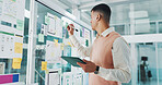 Man, sticky note and glass wall for app development, tablet and documents with review for charts. Person, board and planning for brainstorming, software innovation and ux design at digital agency