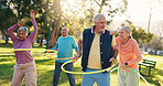 Senior people, group and exercise with hoop at park for active retirement, health or laugh. Elderly friends, ring and fitness outdoor, funny joke or workout for balance at wellness class for cardio
