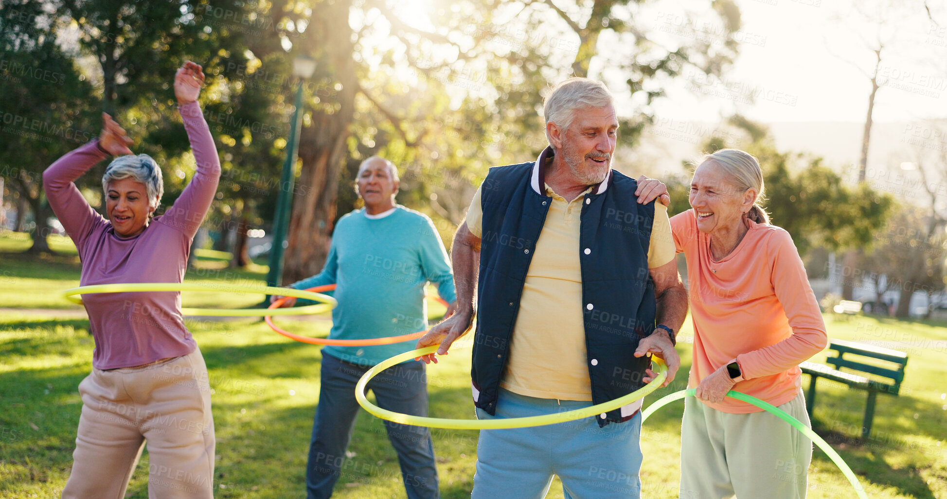 Buy stock photo Senior people, group and exercise with hoop at park for active retirement, health or laugh. Elderly friends, ring and fitness outdoor, funny joke or workout for balance at wellness class for cardio