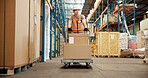 Logistics, trolley and man in warehouse with stock, shipment prep or inventory management in delivery. Distribution, ppe and loader in depot with box, dropshipping or export control in supply chain.