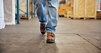 Man, feet and walking in warehouse for supply chain, inventory management and quality assurance. Worker shoes, person and supervisor in storehouse for shipping, distribution and logistics inspection.